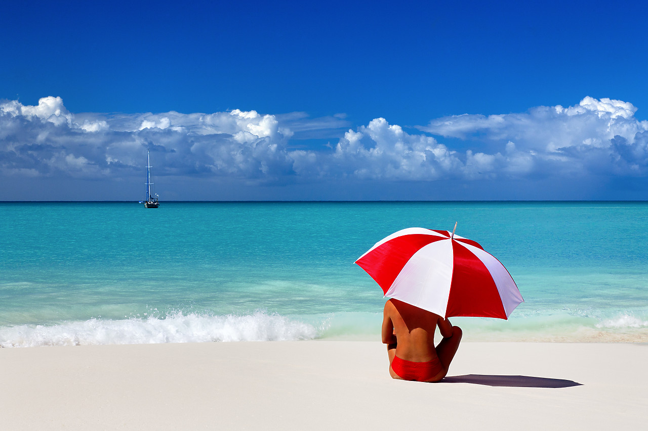 #070003-3 - Woman Sitting on Beach with Red & White Umbrella, Barbuda, Caribbean, West Indies