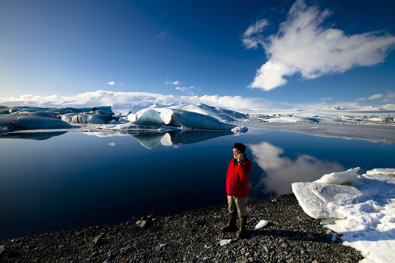 #100080-1 - Man Talking on Mobile Phone, Jškuls‡rl—n Iceberg Lagoon, Iceland