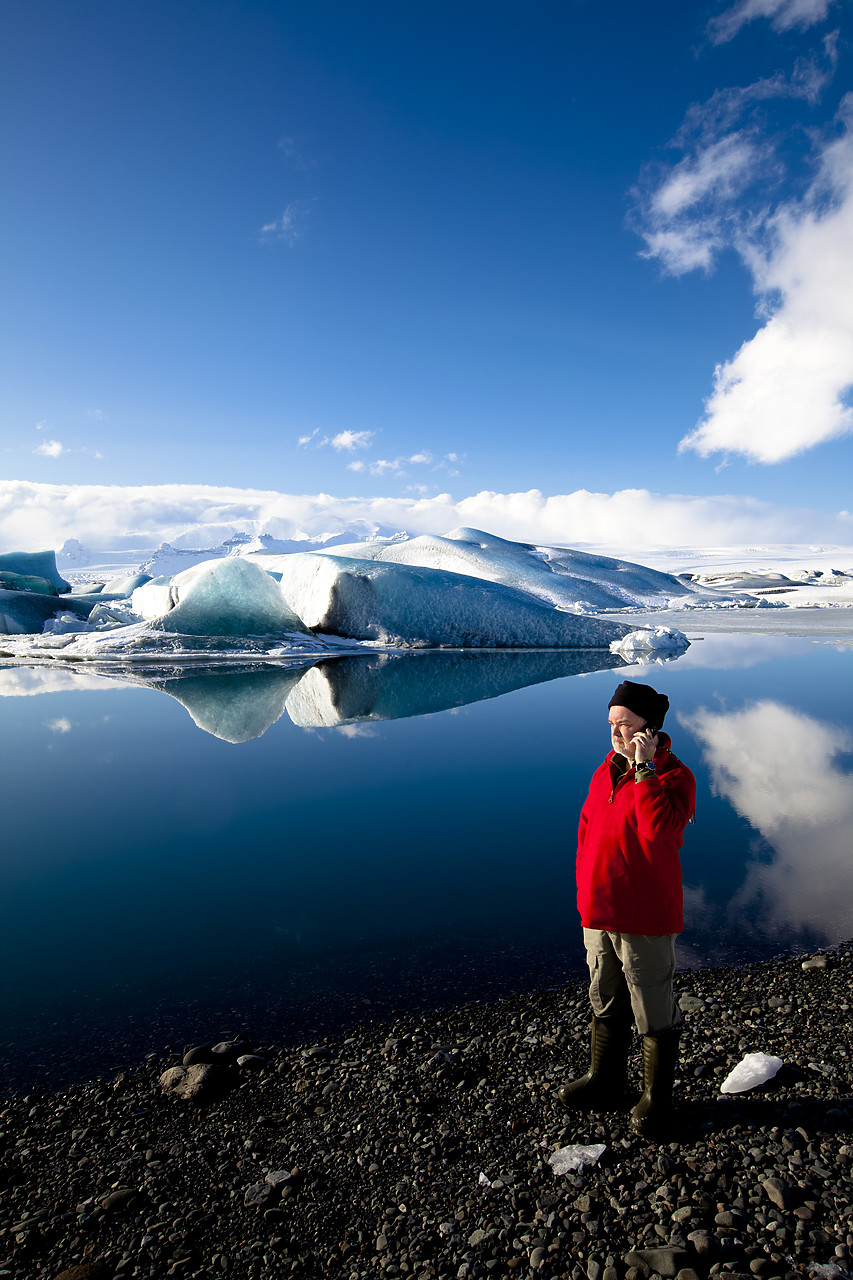 #100080-2 - Man Talking on Mobile Phone, Jškuls‡rl—n Iceberg Lagoon, Iceland