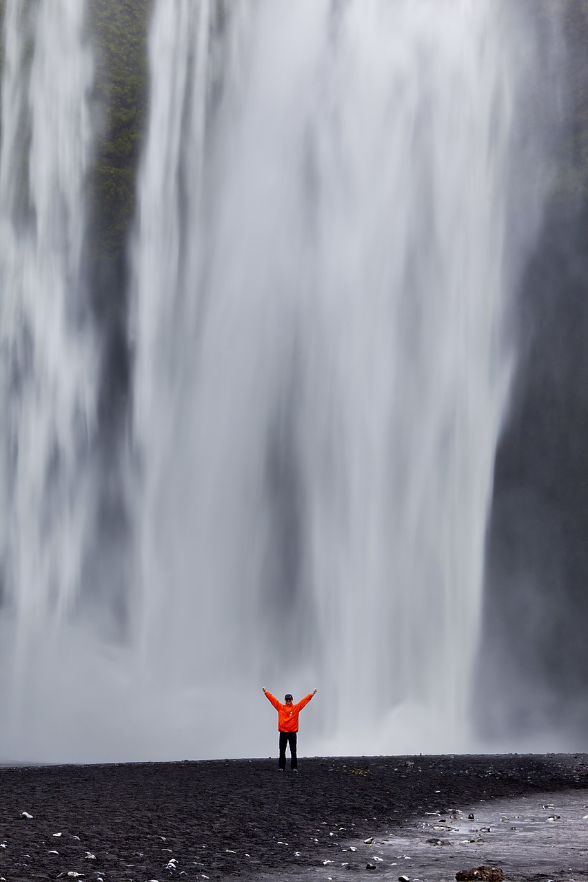 #100322-2 - Man in Front of Skogafoss Waterfall, Iceland